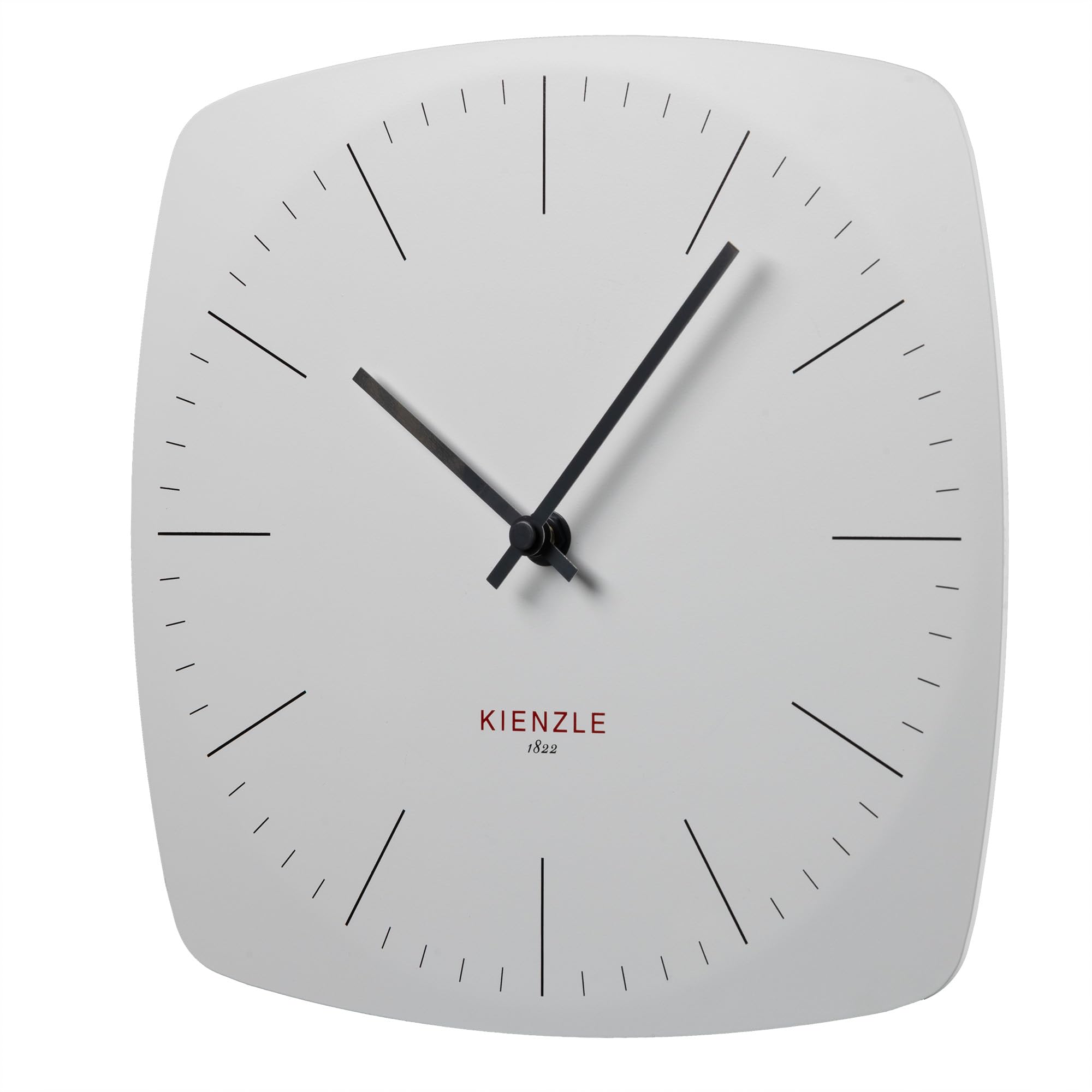 Kienzle DCF Radio-Controlled Wall Clock mounted on a dark green wall above a sofa.
