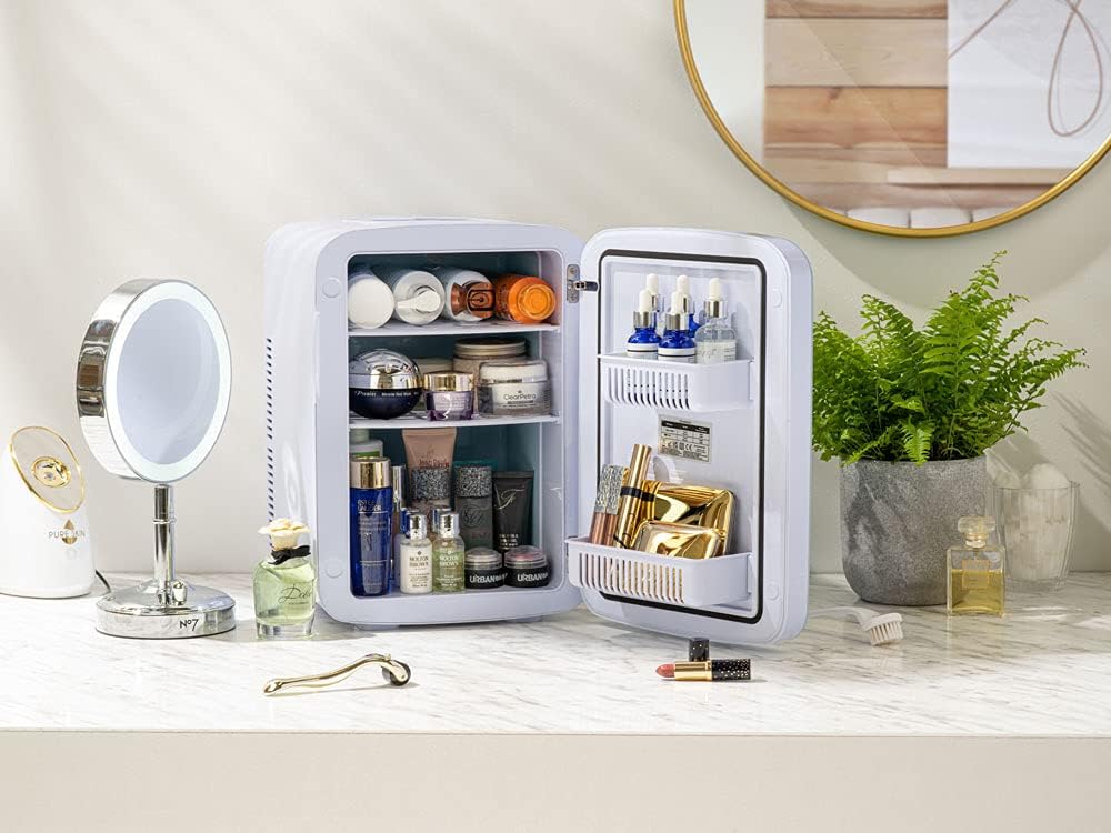 Subcold Ultra 15 Mini Fridge filled with cosmetics on a vanity