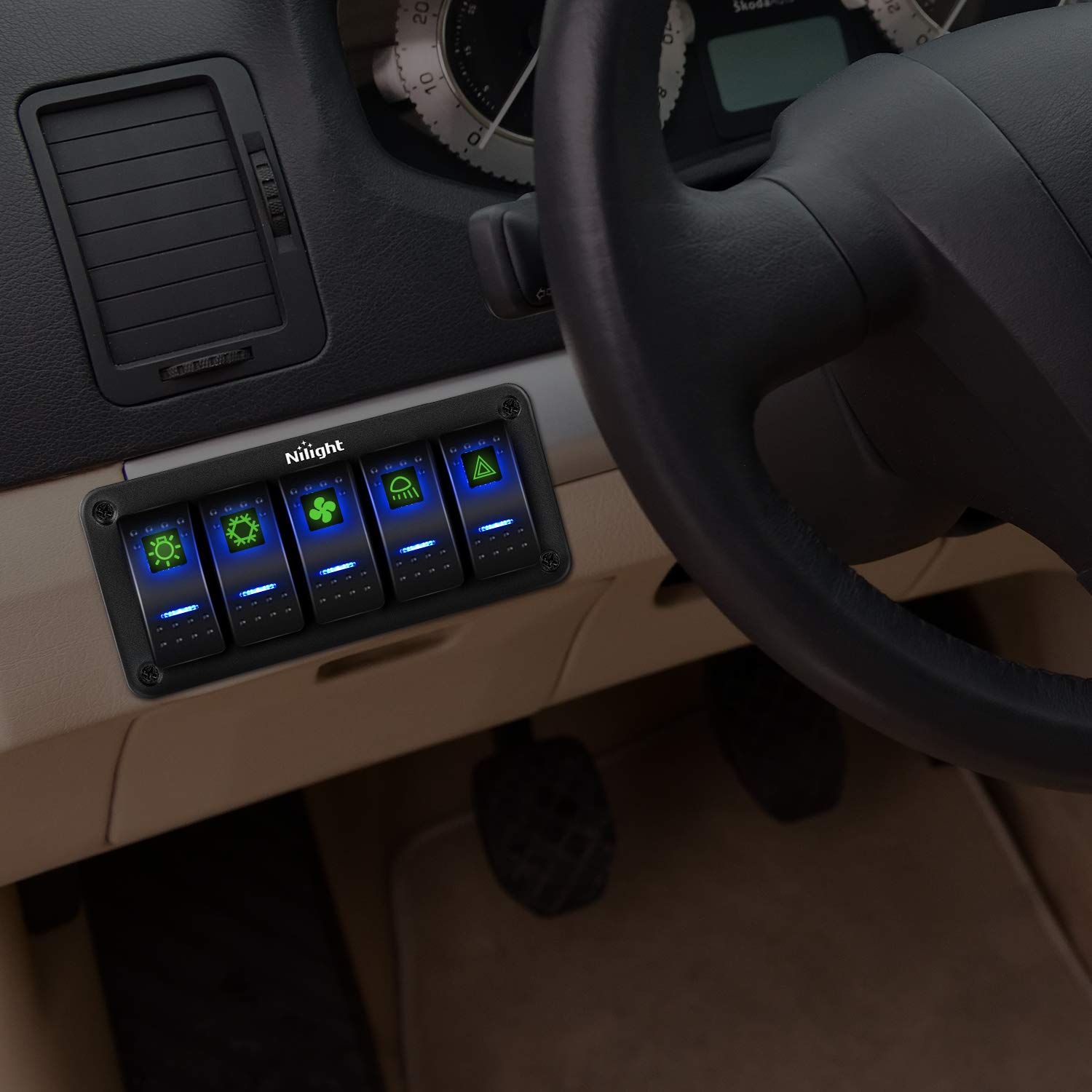 Nilight 5 Gang Rocker Switch Panel installed in a vehicle dashboard, showing the illuminated blue LED switches controlling various functions like lights and fans.