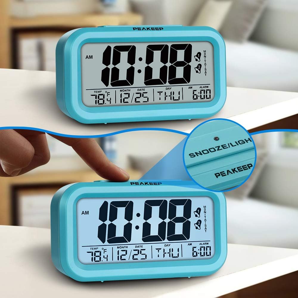 Peakeep Digital Alarm Clock showing the snooze/light button and the display illuminating.