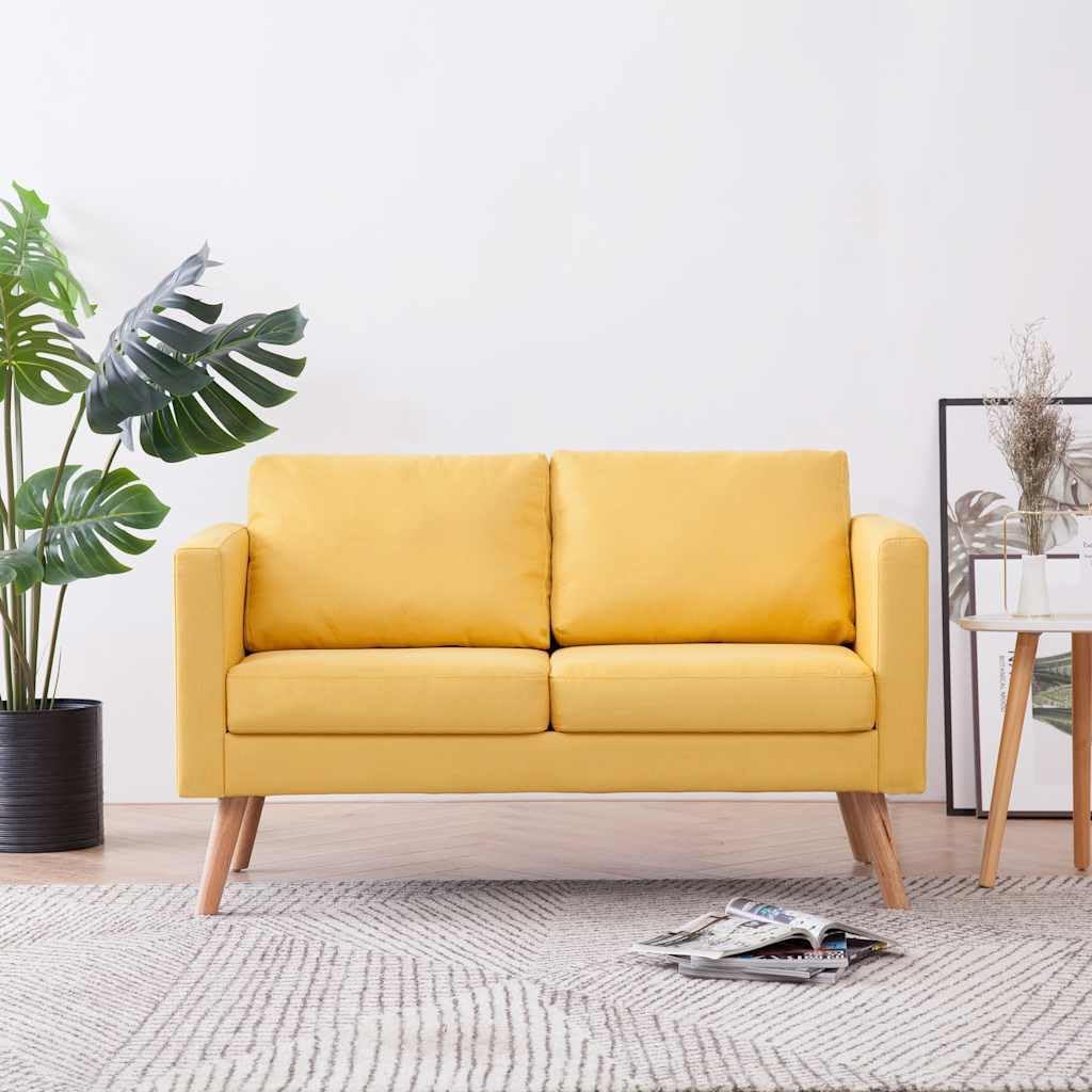 Front view of the assembled vidaXL 2-Seater Sofa in yellow fabric with wooden legs, placed on a patterned rug in a living room setting.