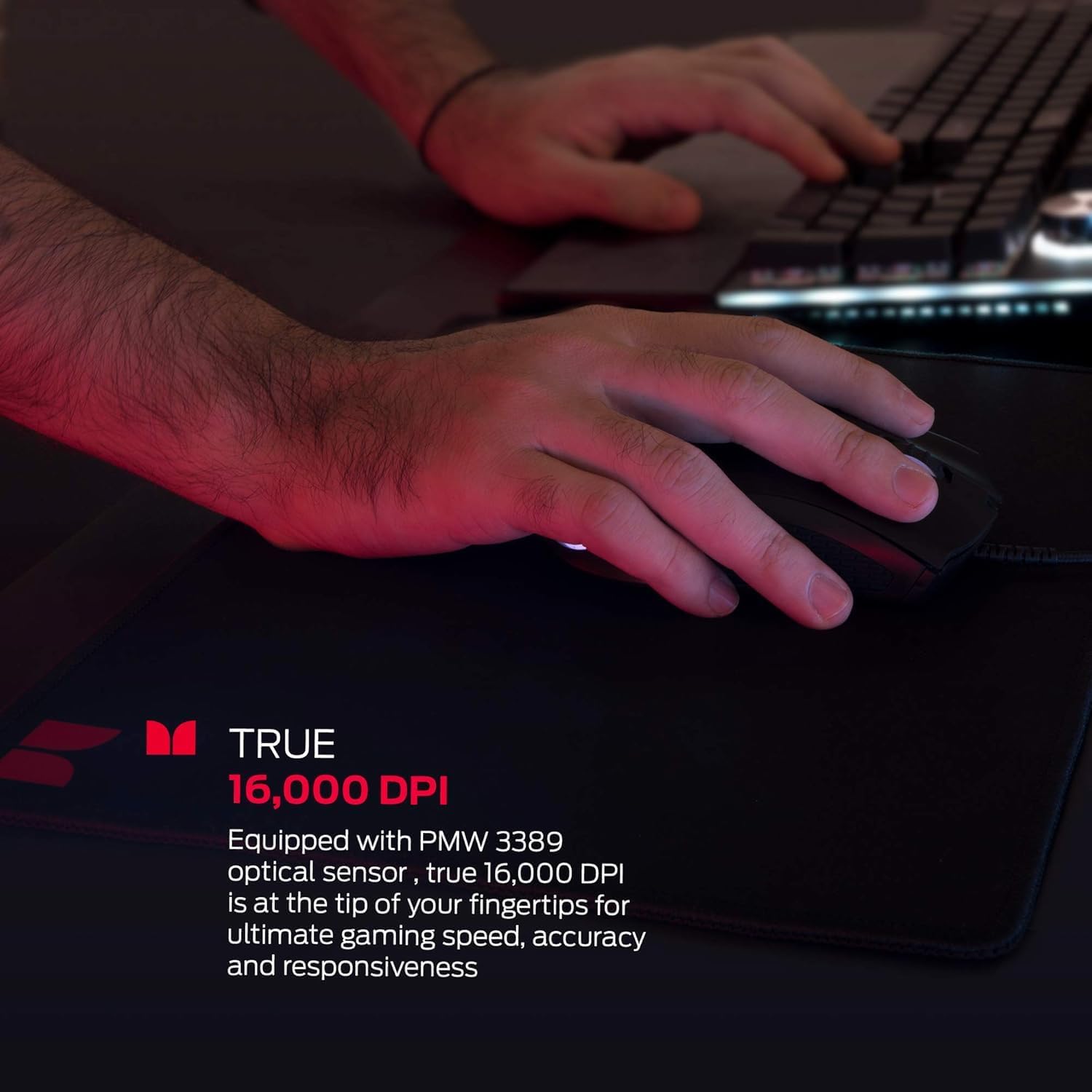 Hand using Monster Alpha 9.0 gaming mouse on a mouse pad, highlighting 16,000 DPI sensor