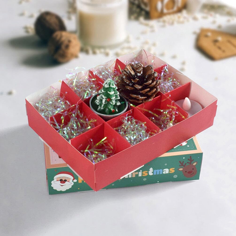 An open Advent Calendar Box filled with small decorative items like a pinecone, a miniature Christmas tree, and shiny tinsel.