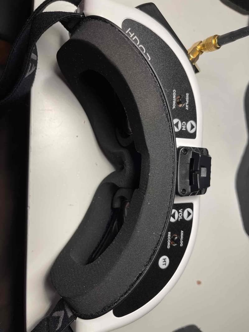 A new black foam pad securely installed on a white FPV goggle faceplate, showing a snug fit.