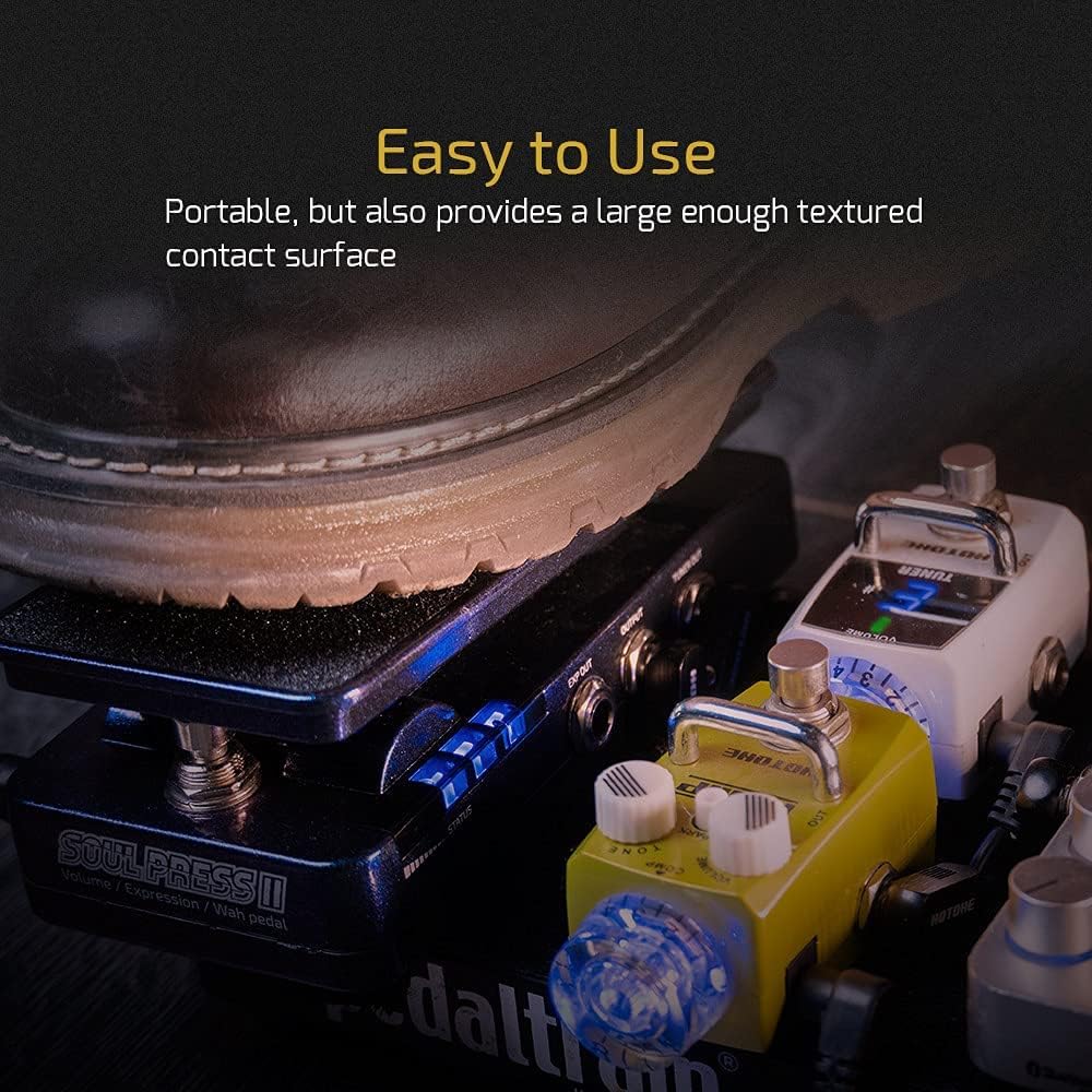 A foot pressing down on the Soul Press II pedal, surrounded by other guitar pedals, illustrating its compact and easy-to-use design.