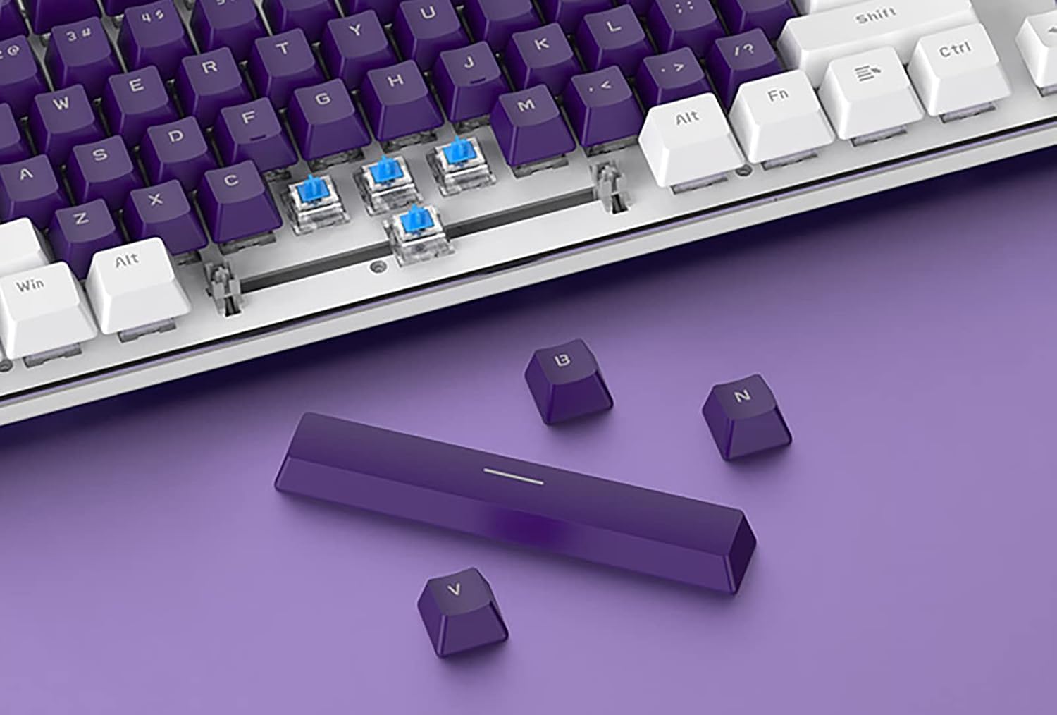Close-up of the Lomiluskr AK35i keyboard with several keycaps and switches removed, demonstrating the hot-swappable design.