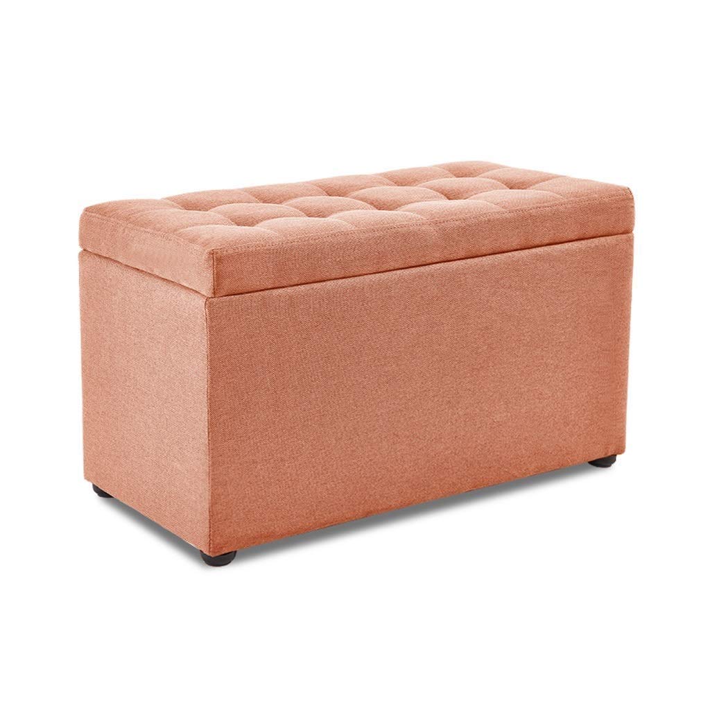 Siège tabouret repose-pieds orange pour optimiser le rangement des petits salons