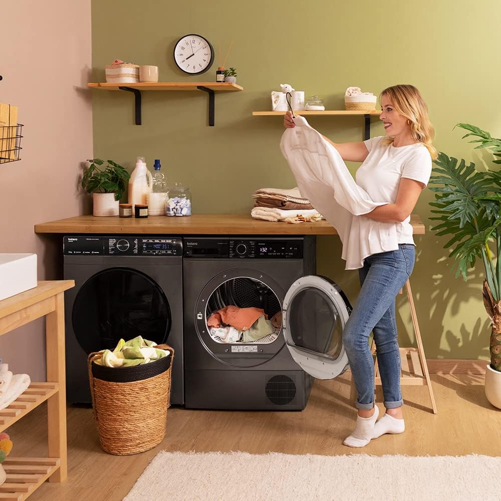 User loading laundry into the dryer