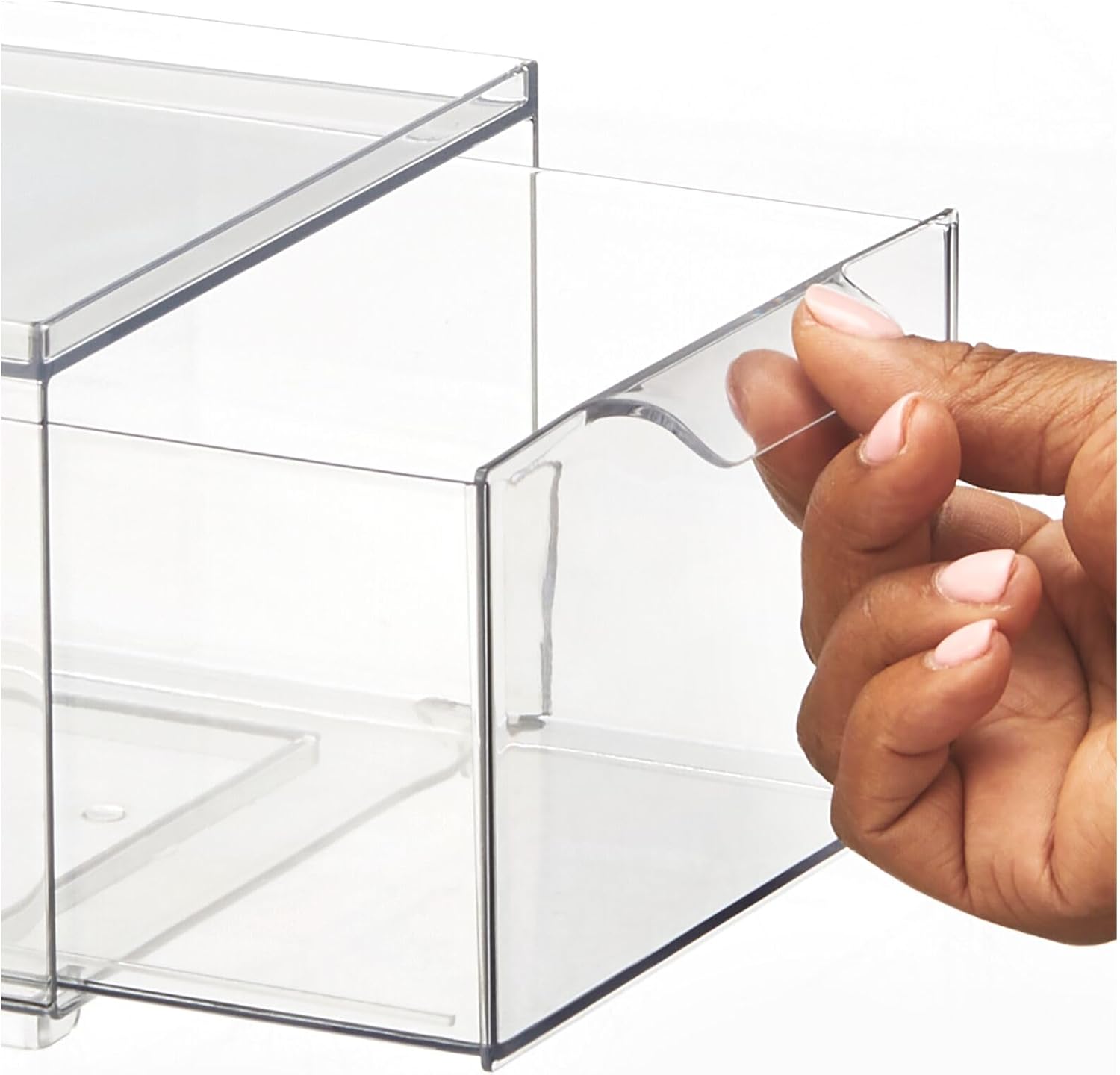 A hand pulling out the clear plastic drawer from an organizer bin.