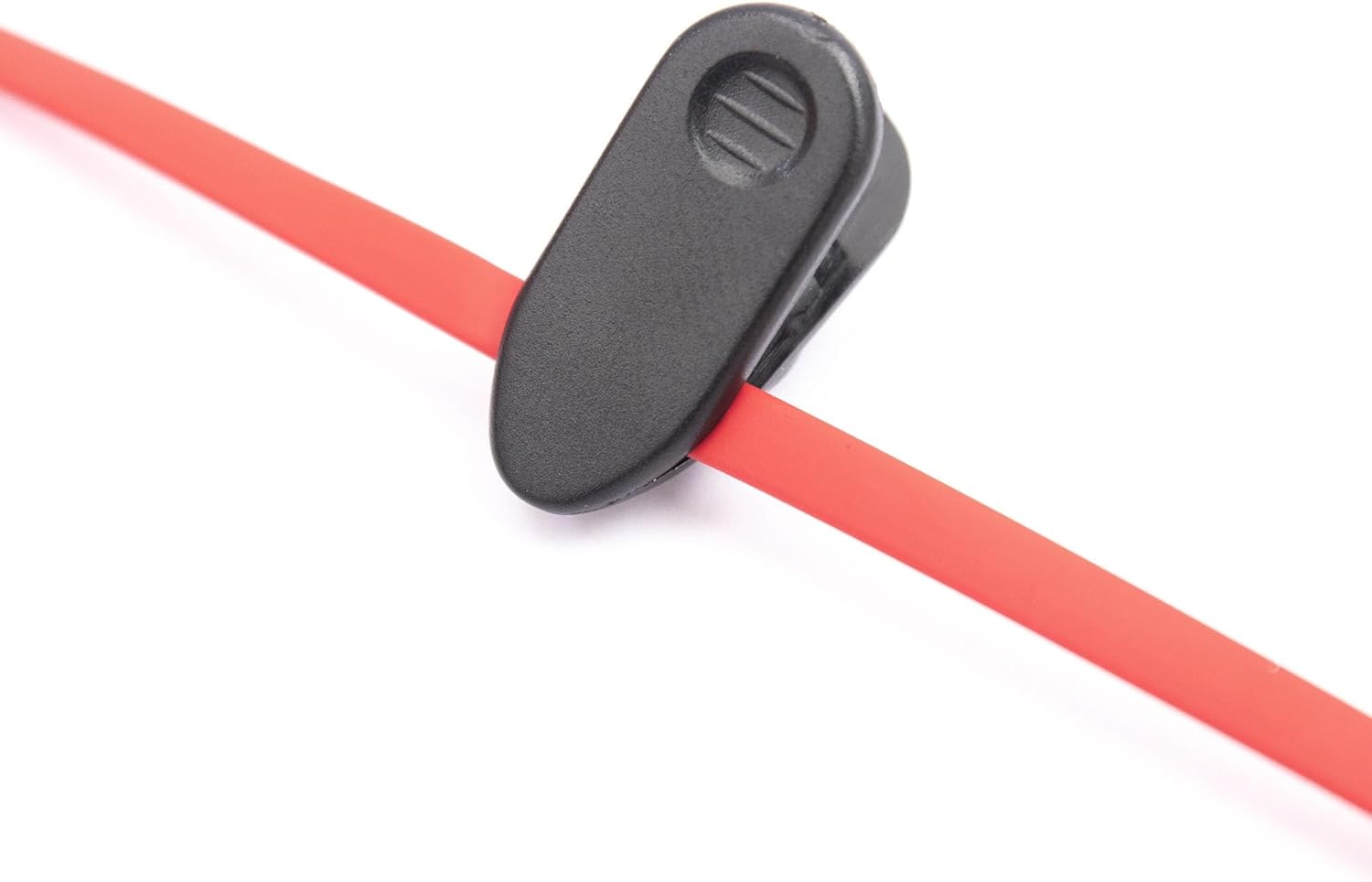 Detallada view of the inline control unit with volume buttons and microphone on the red flat cable of the RadioShack earphones.