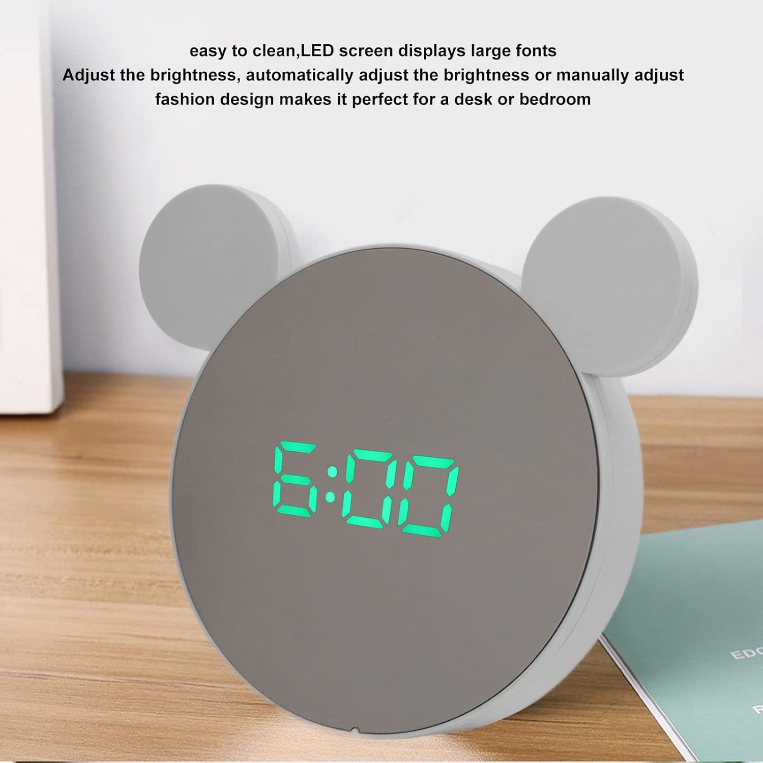 Digital alarm clock displaying 6:00, highlighting its large LED fonts and adjustable brightness feature.