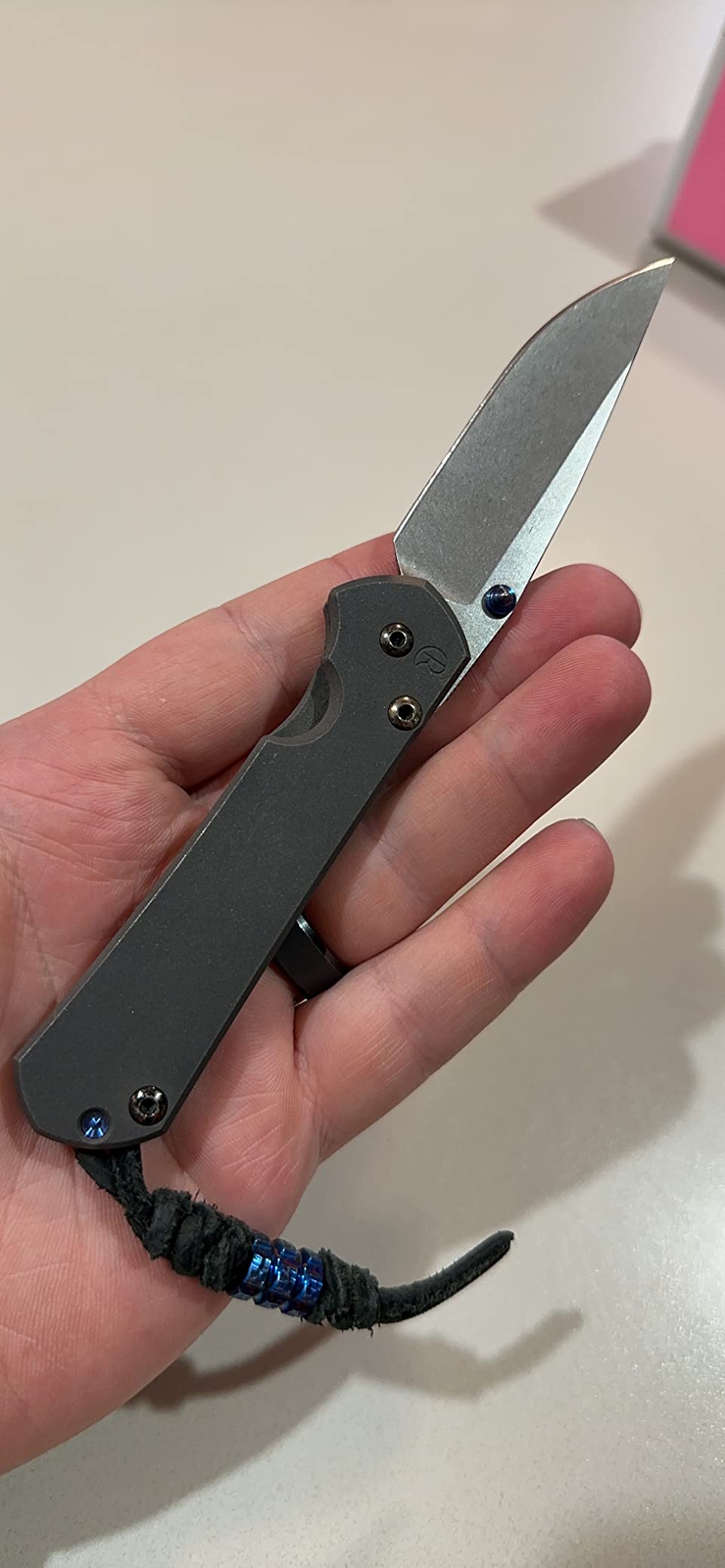 Macro shot of titanium frame lock interface and bead-blasted finish on a premium folding knife
