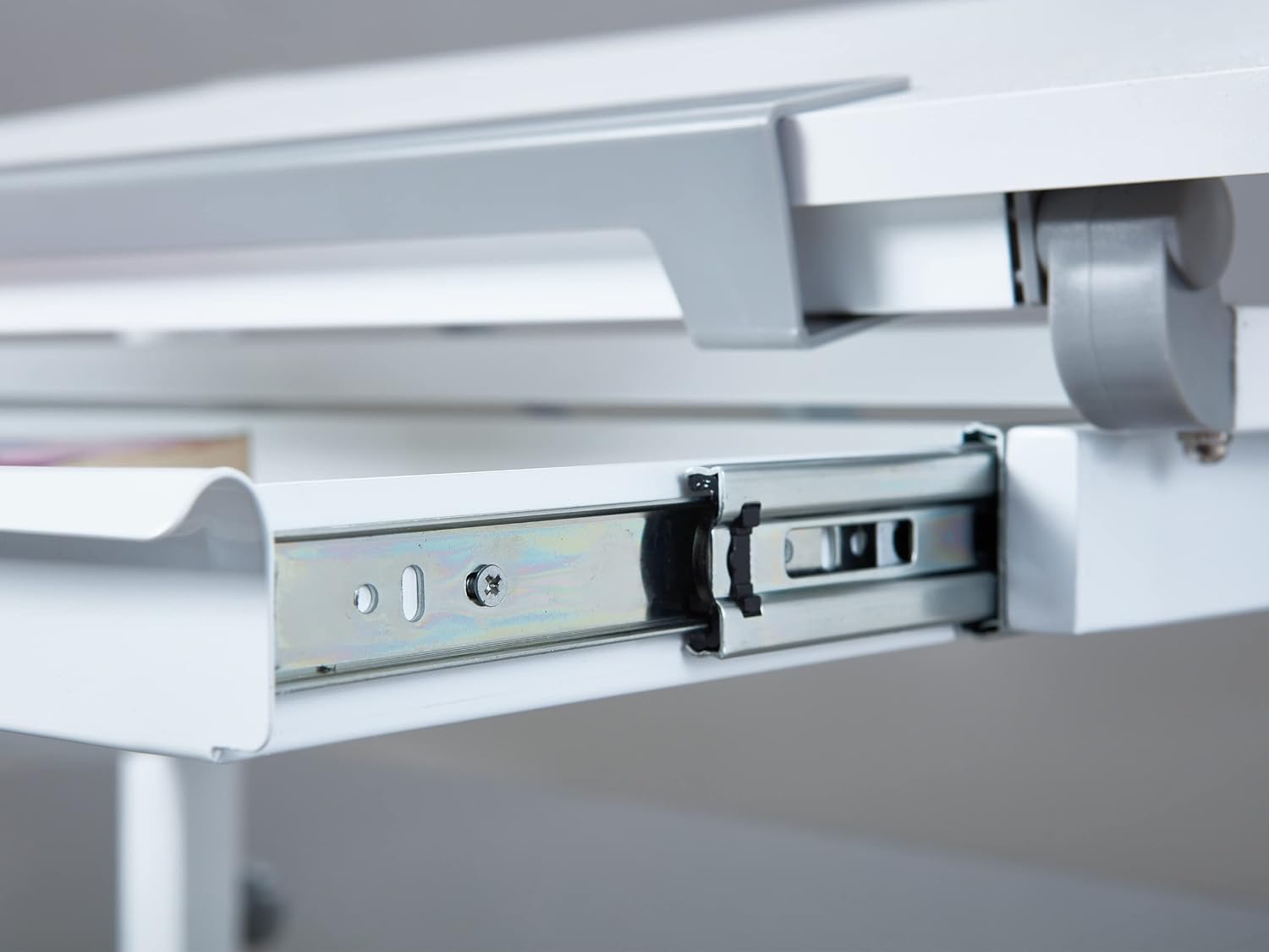 Close-up of the desk's integrated drawer or foldable shelf mechanism, showing the smooth glides