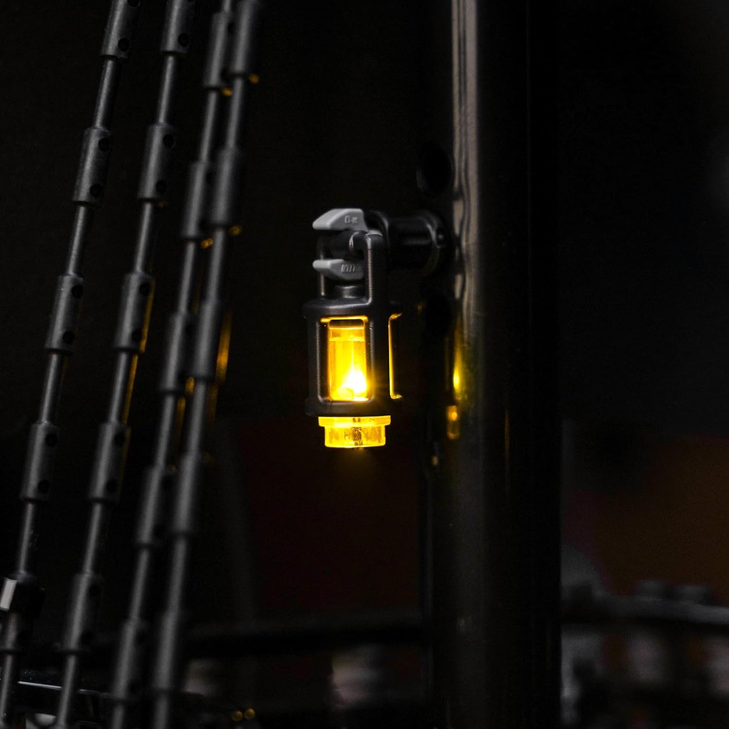 Close-up of a mast-mounted lantern on the LEGO Pirate Ship, emitting a warm yellow glow.