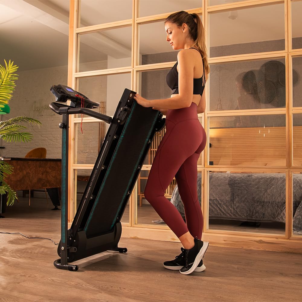 Woman folding the treadmill into a vertical position for storage