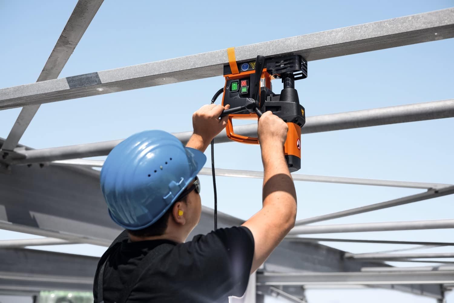 Worker using Fein KBE 32 QW for overhead drilling