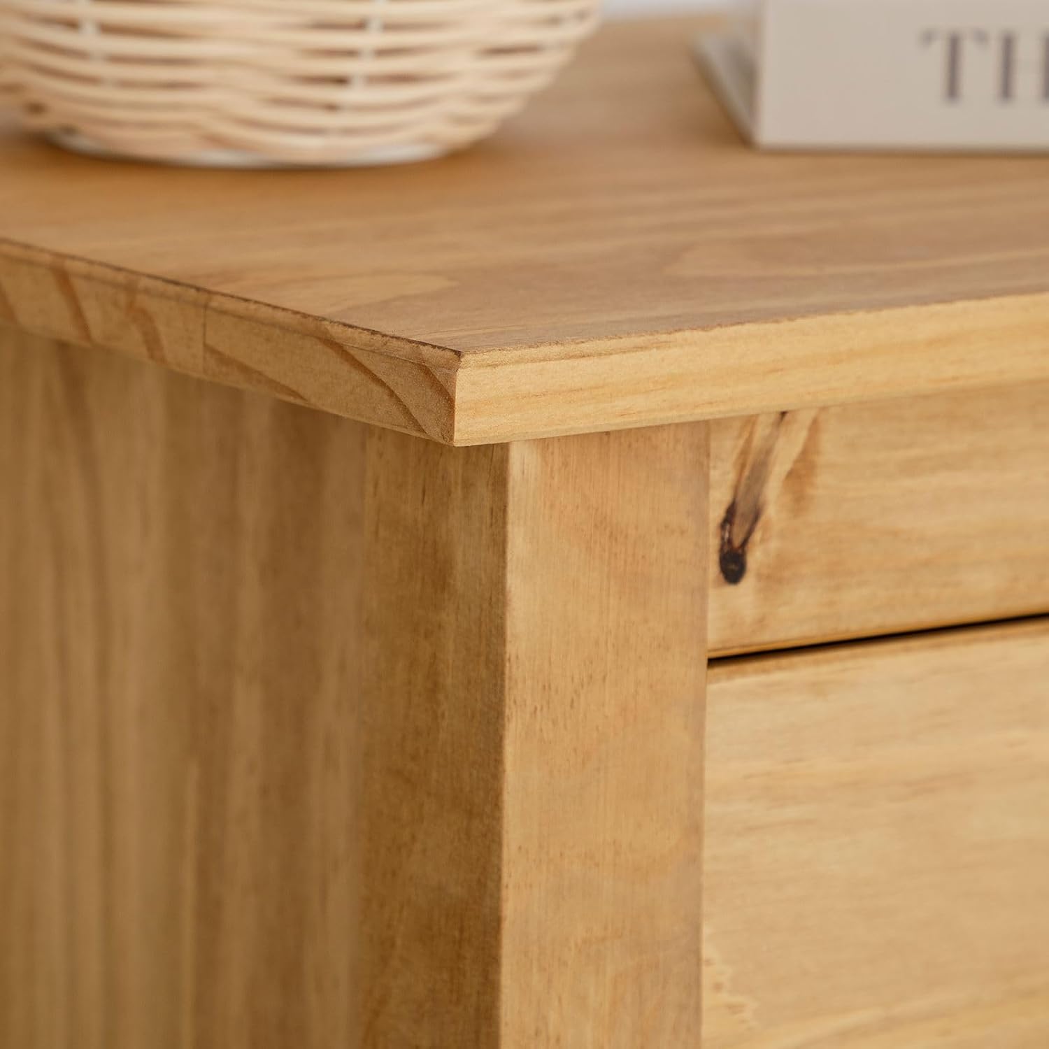 Close-up of the corner of the IDIMEX Tilly Bedside Table top, showing wood grain and finish