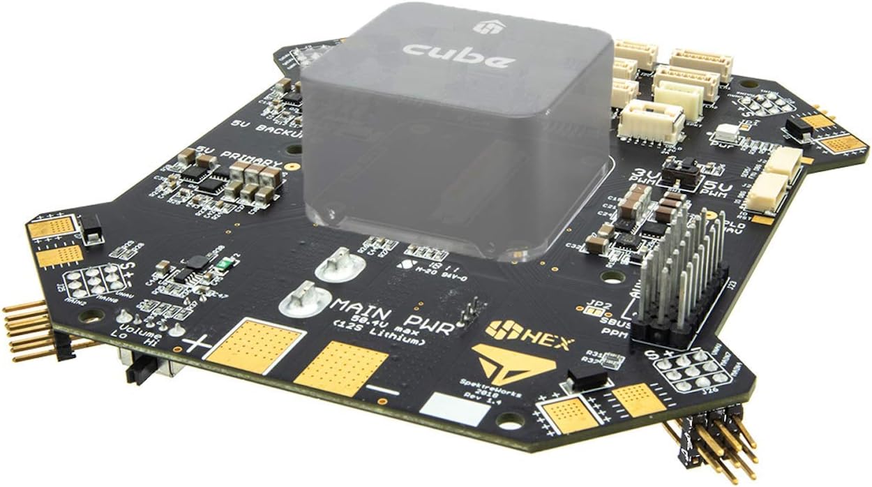 Top view of the Cube Kore carrier board with a translucent Pixhawk Cube module placed on top, showing various connectors and components.