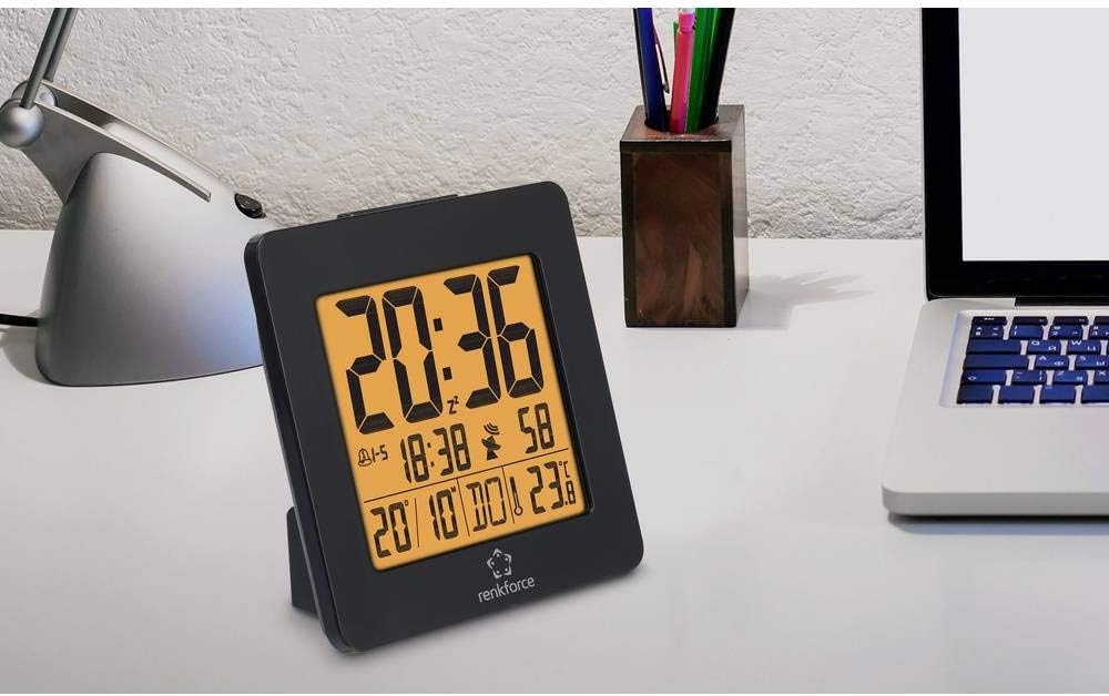 Renkforce 4161c12 Radio Controlled Alarm Clock placed on a white desk next to a laptop and desk lamp.