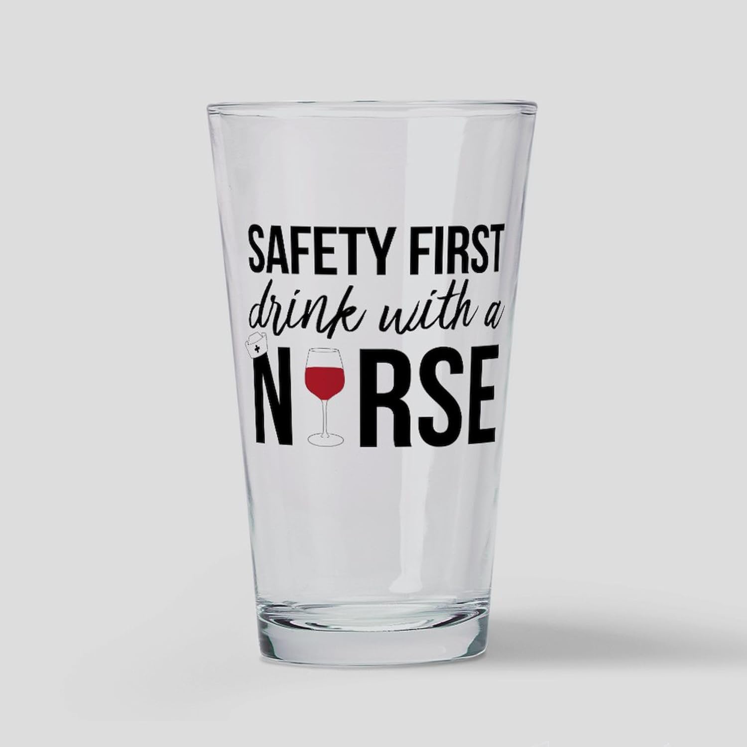 CafePress Safety First Drink With A Nurse Pint Glass, 16 oz. Drinking Glass