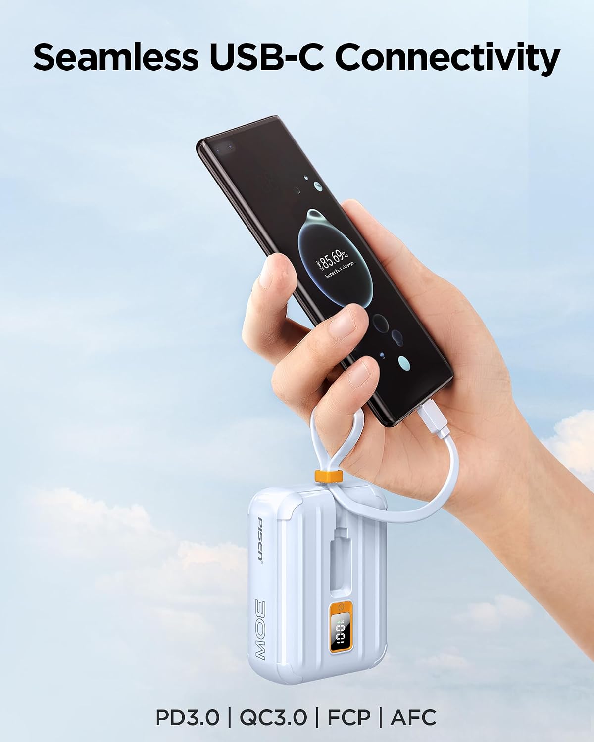 A hand holding the PISEN power bank connected via its built-in USB-C cable to a smartphone, showing the phone charging.