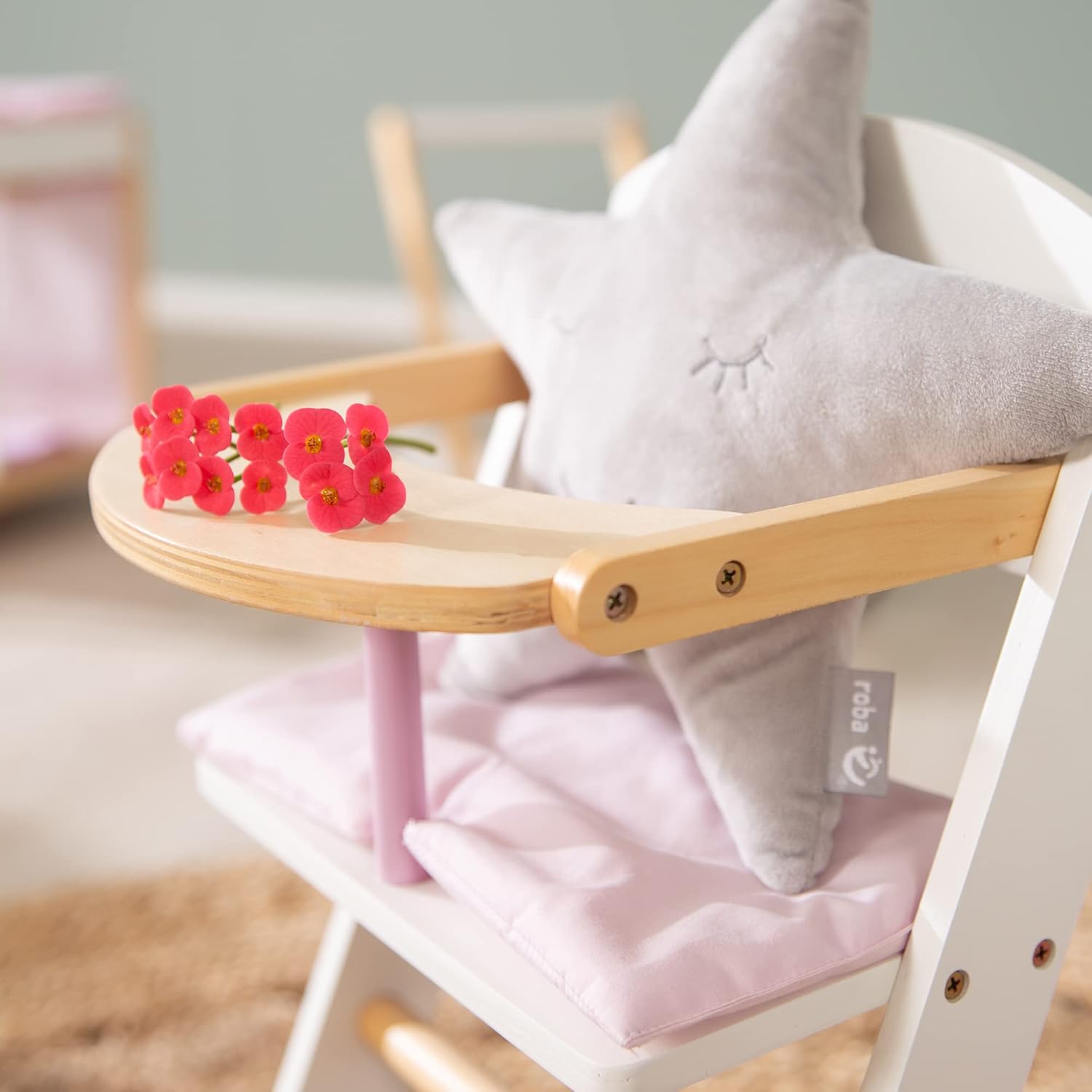 Close-up of doll high chair tray with flowers