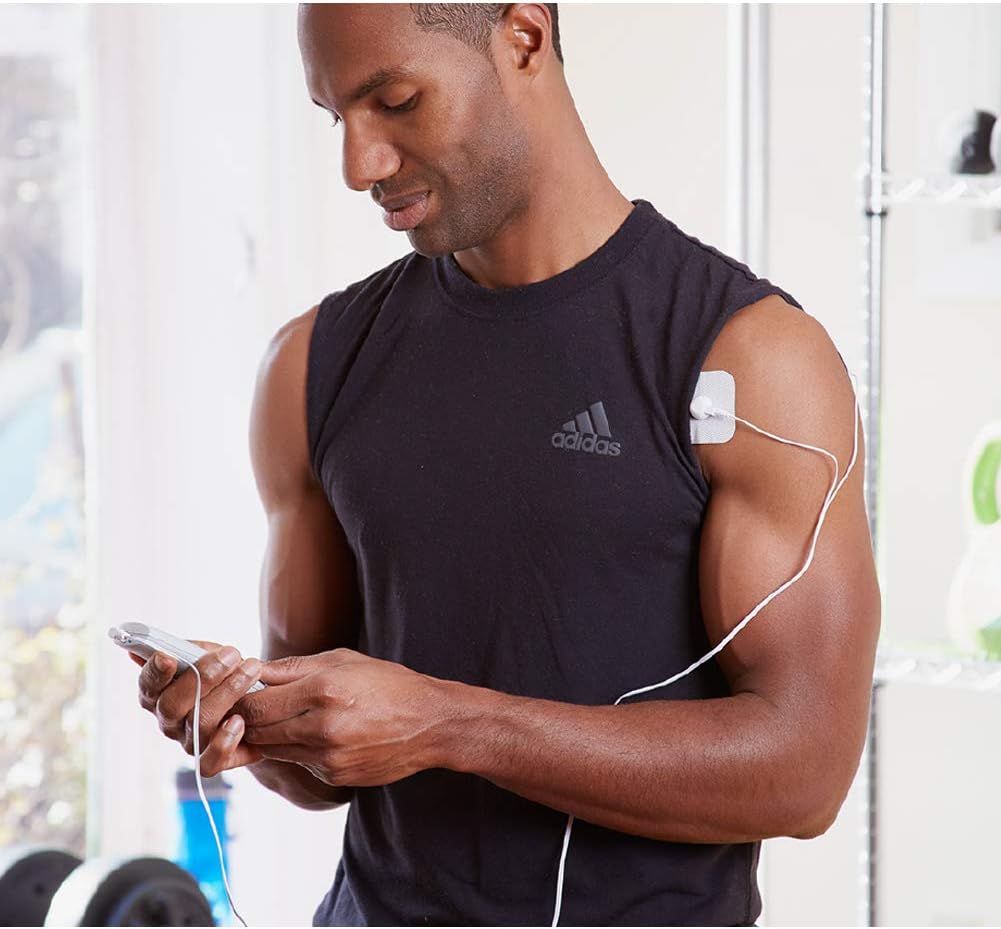 Man applying AccuRelief TENS unit electrode to his shoulder.