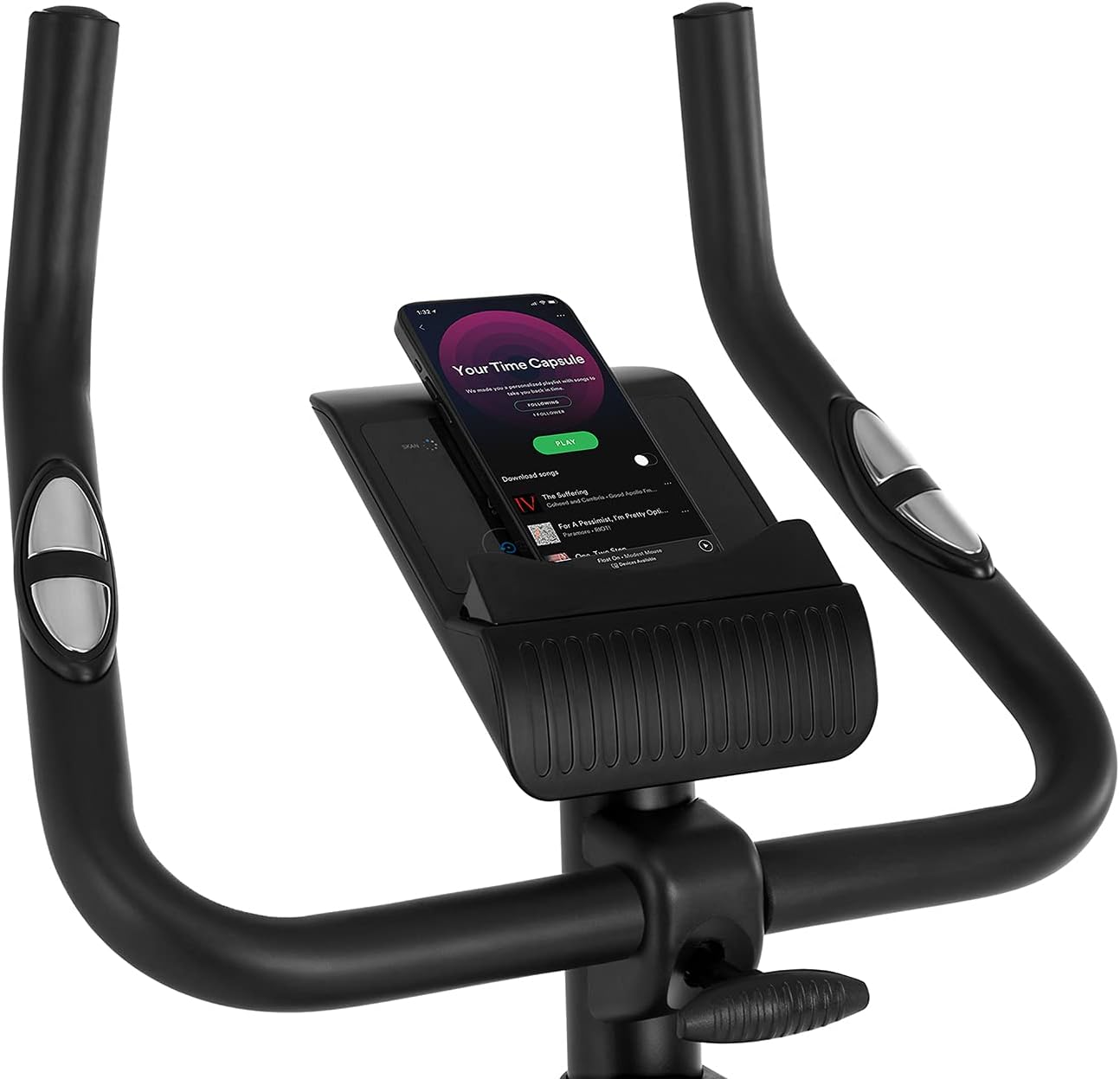 A hand adjusting the tension control knob on the ZIPRO Boost Exercise Bike.