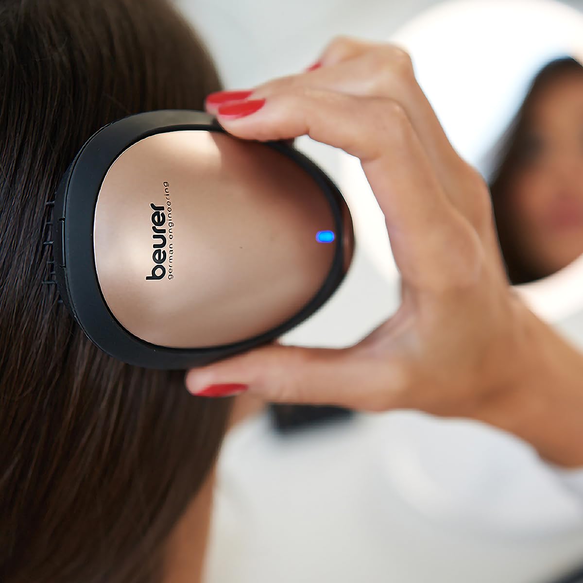 Close-up of the Beurer HT10 Electric Detangling Brush with the blue ion indicator light on