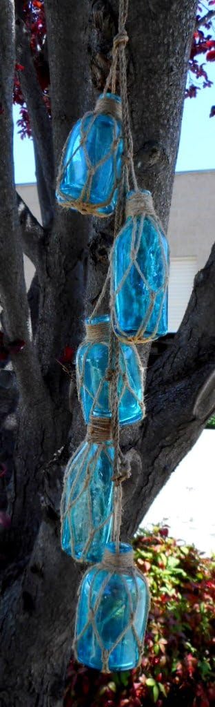 UD Set of Five Assorted Light Blue Glass Buoy Bottles Hanging by Natural Netted Jute Rope