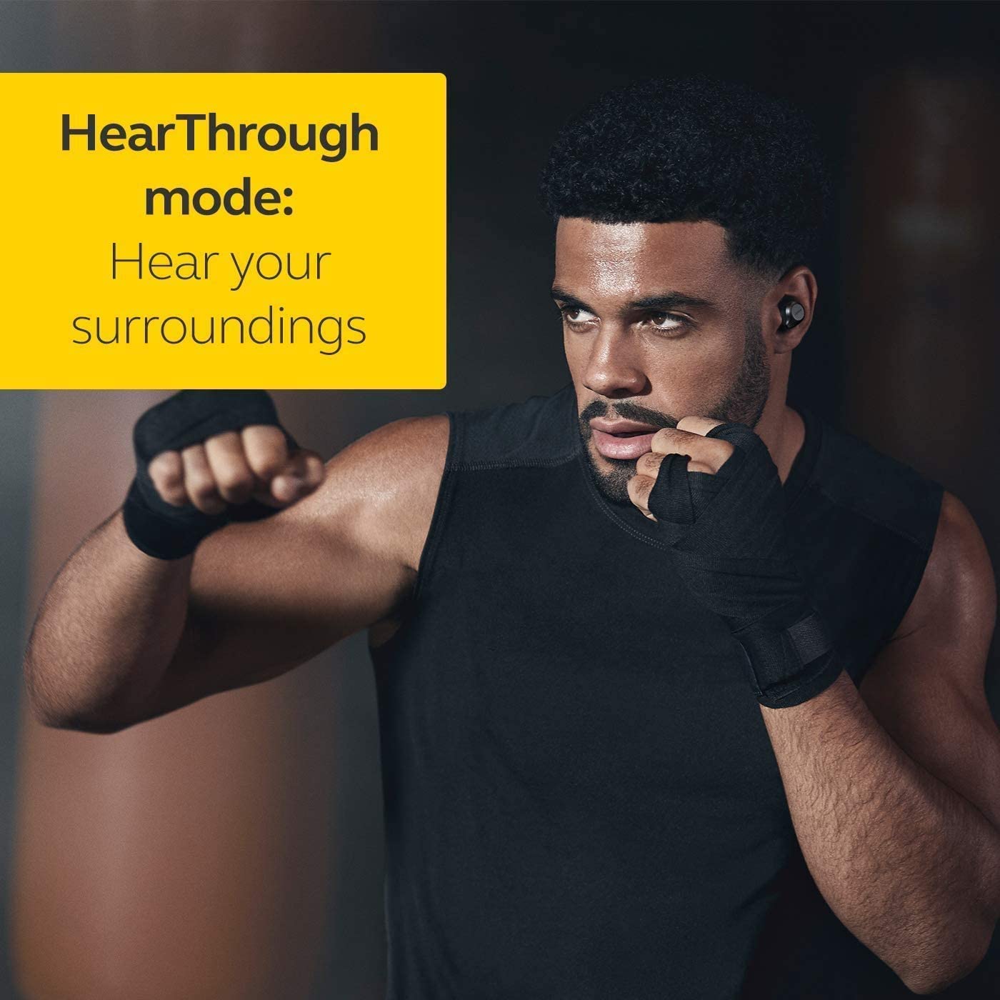 Man in a gym setting, demonstrating HearThrough mode