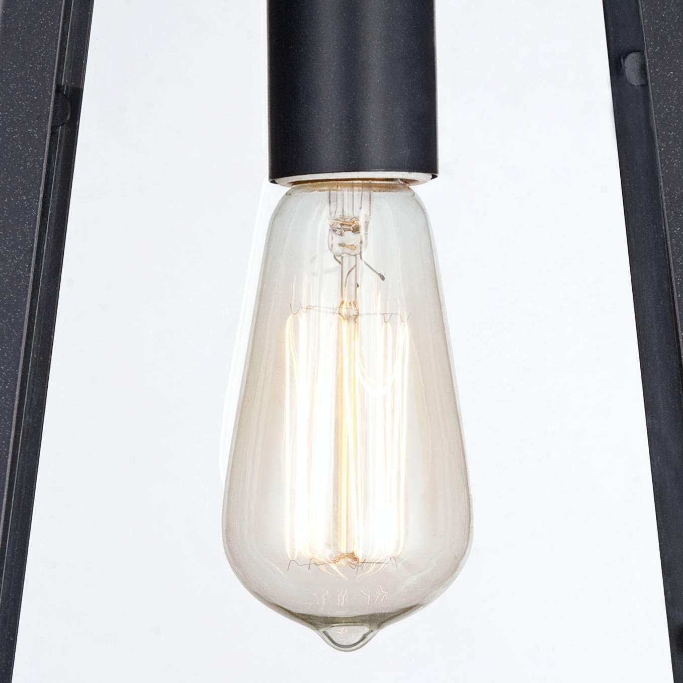 Close-up of an Edison-style filament bulb inside the John Timberland Arrington wall light.