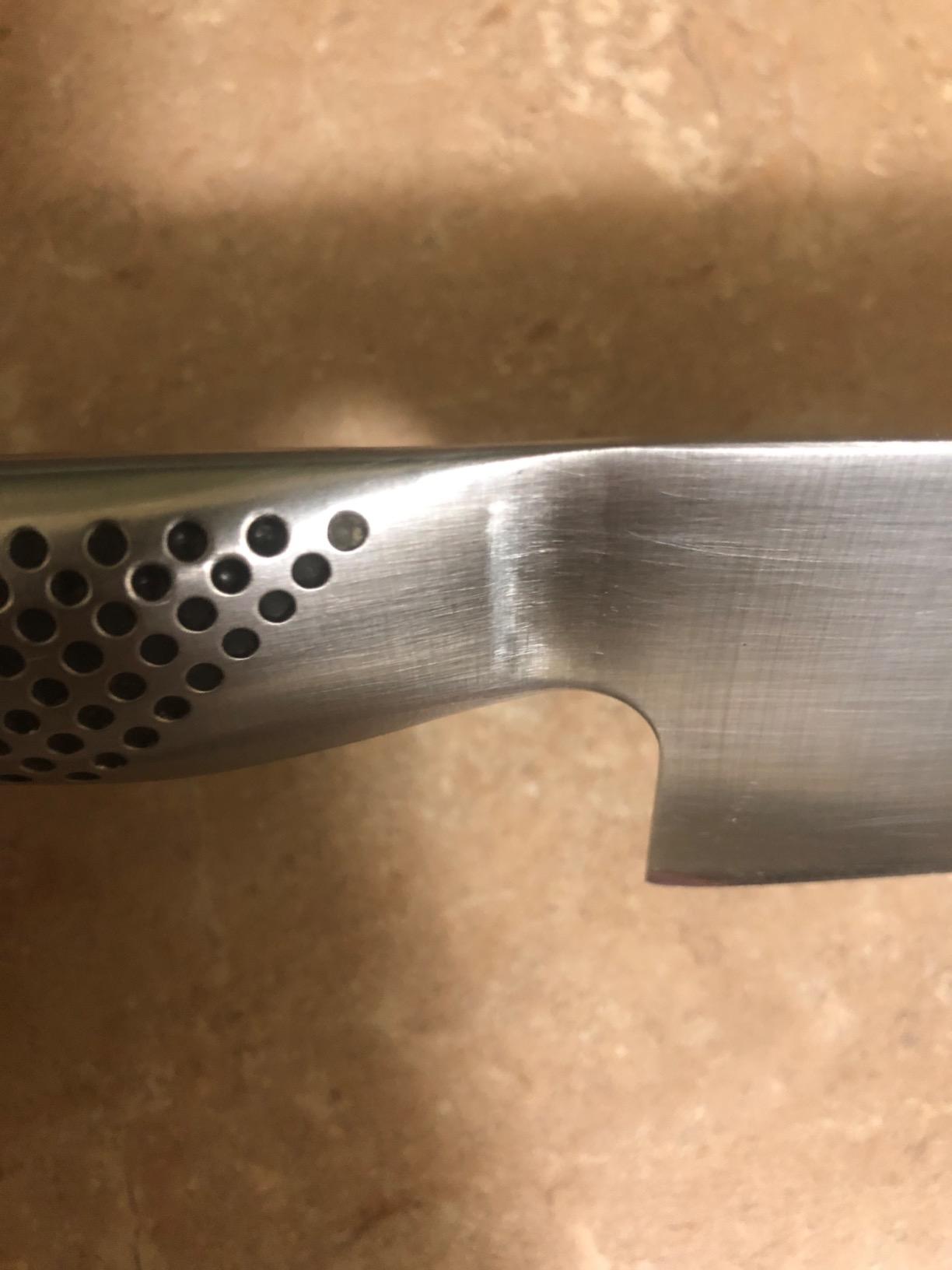 Global G-2 knife on a cutting board with vegetables