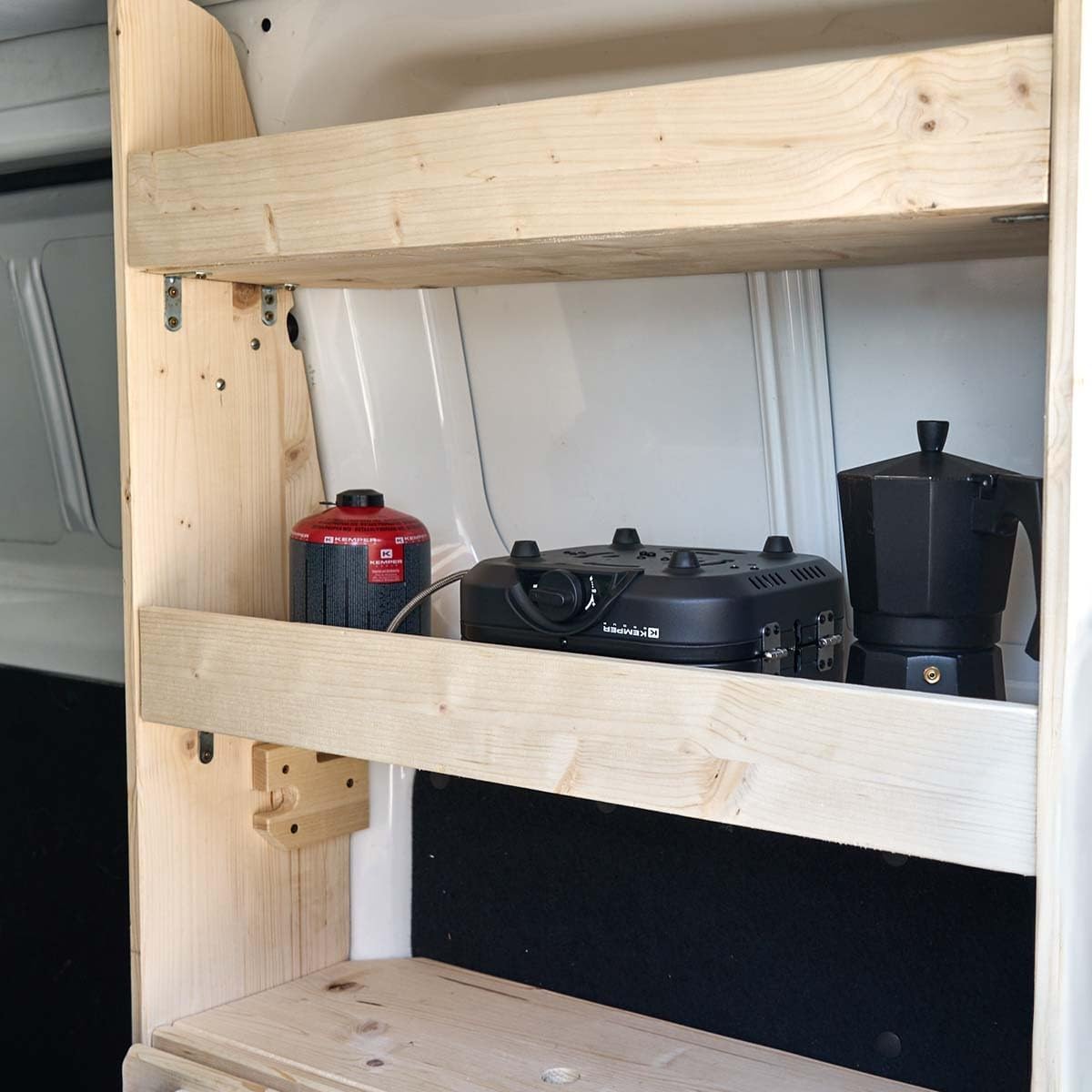 KEMPER PK5809 stove folded and stored on a wooden shelf with a gas cartridge