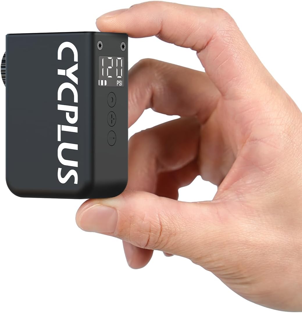 The CYCPLUS AS2 Ultra pump held in a person's hand, showing its compact size.