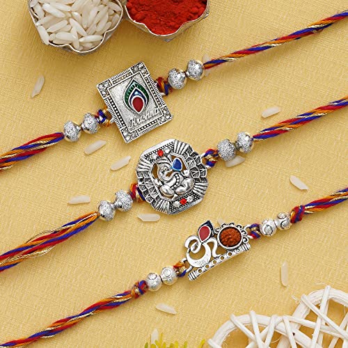 Image of eCraftIndia Set of 3 Rakhi Combo Hamper | Om Krishna Peacock Feather Lord Ganesha Silver Religious Designer Rakhis | Roli Chawal Pack