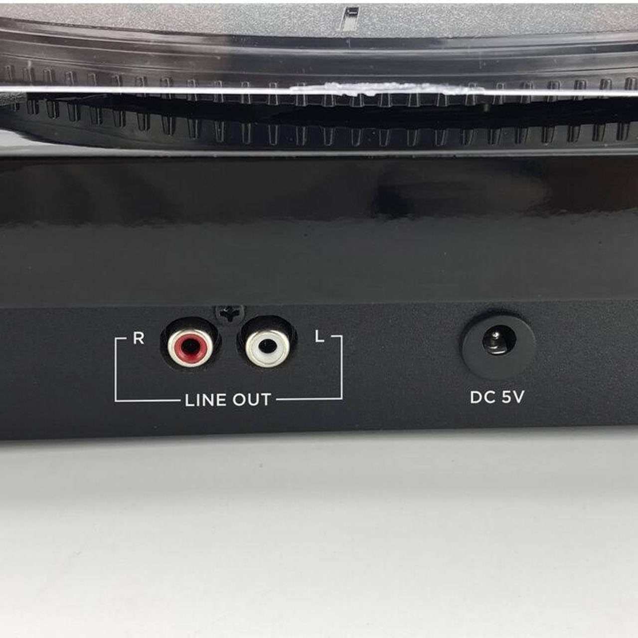 Close-up of the RCA Line Out ports and DC 5V power input on the back of the AIWA LPS-25BK Turntable.
