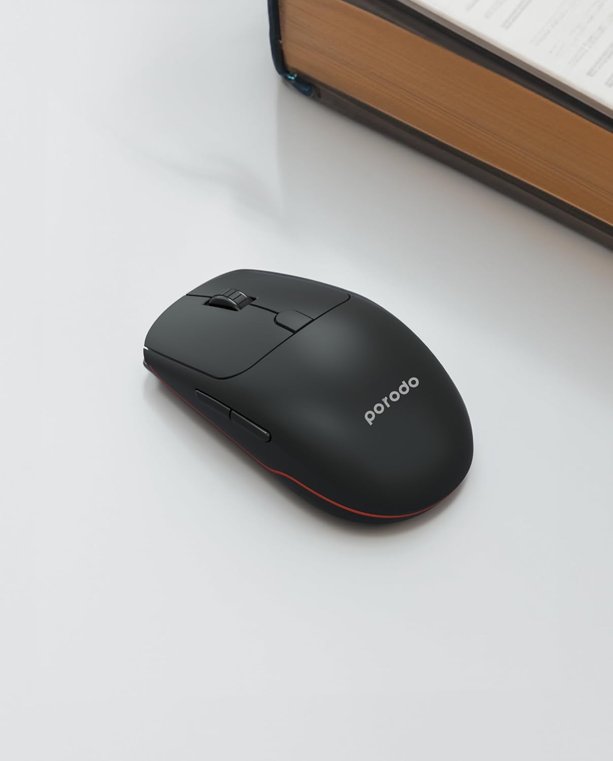 Angolato view of the Porodo PD-21MIOM-BK wireless mouse, showcasing its ergonomic shape and side buttons.