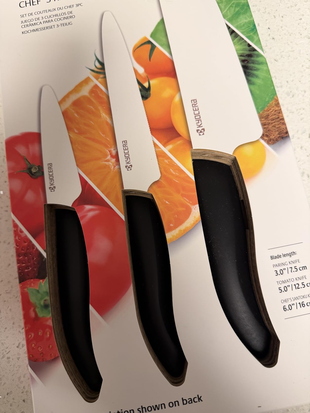 Kyocera ceramic chef knife on a wooden cutting board