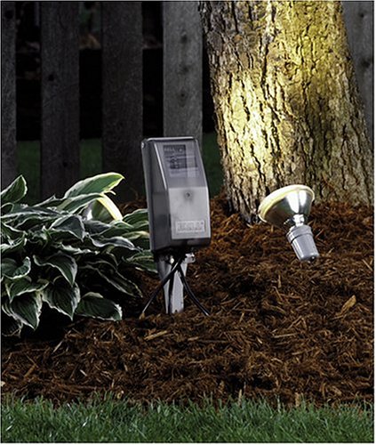 Hubbell FB3003 power strip mounted on a stake in a garden, powering an outdoor spotlight.