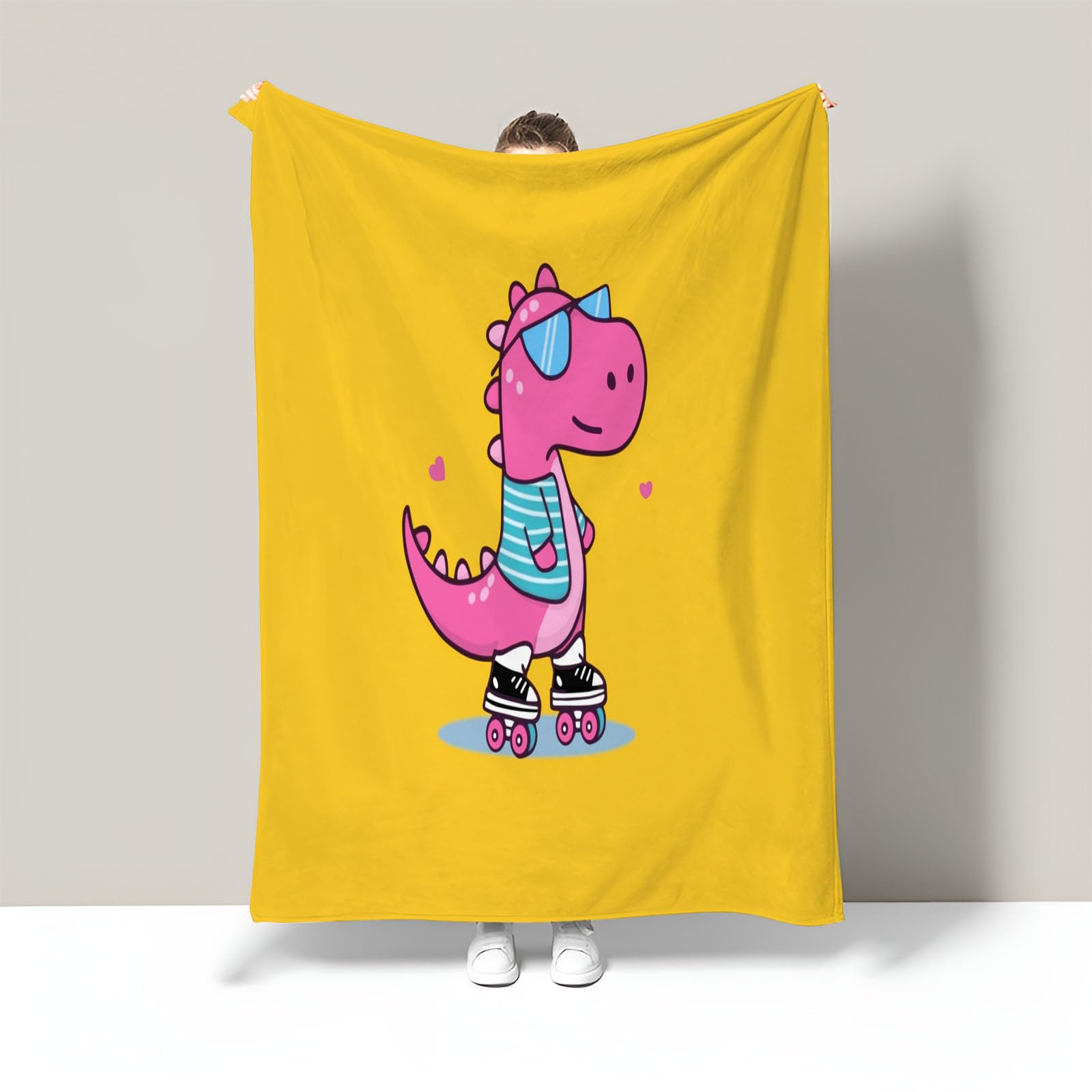 Couverture dinosaure rose pour des soirées cocooning chaleureuses dans le salon ou la chambre