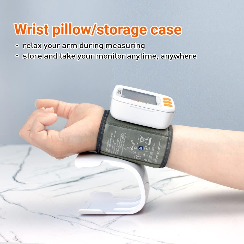 Hand wearing the Scian wrist blood pressure monitor, resting on a white wrist pillow/storage case
