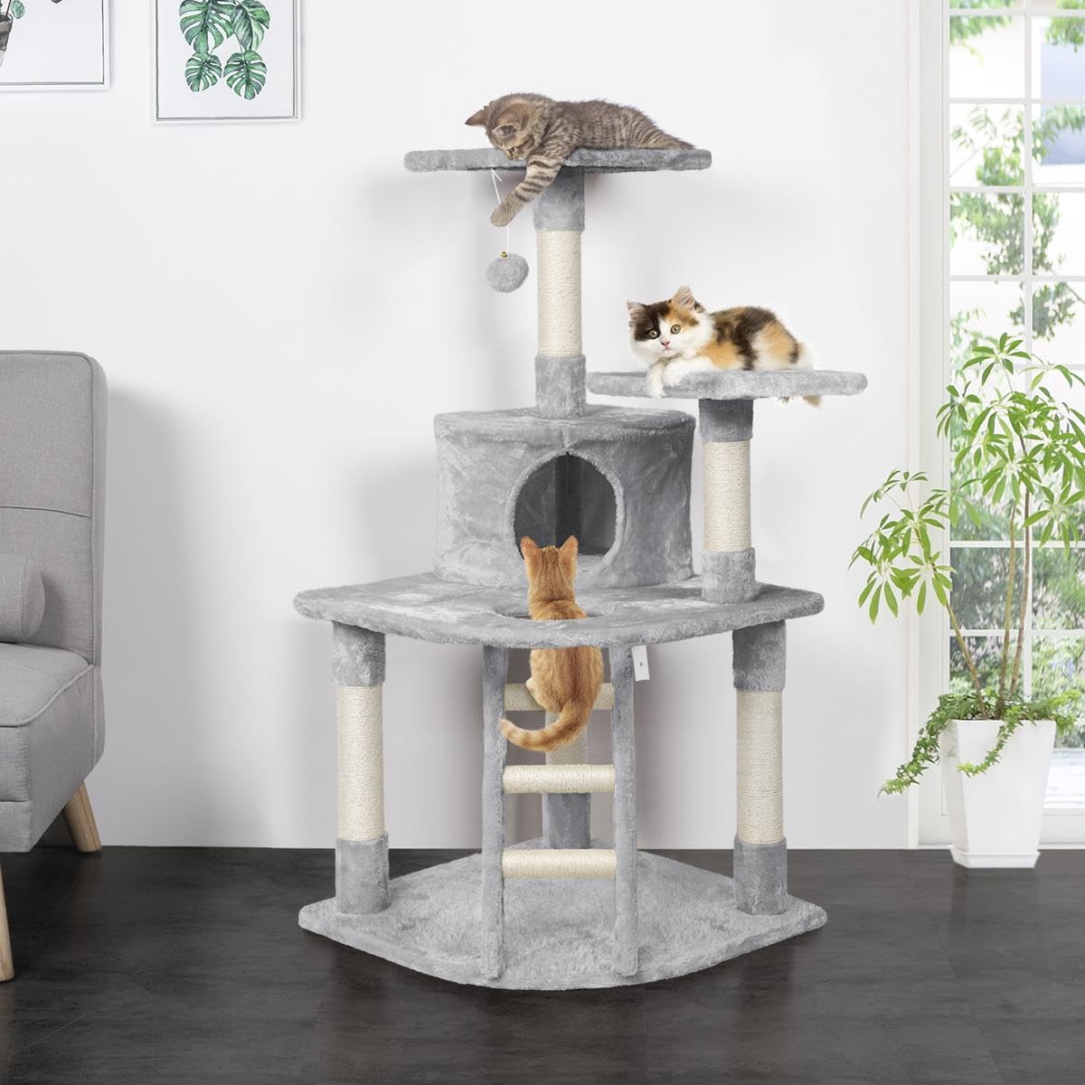 Fully assembled Yaheetech 48-inch cat tree with multiple cats interacting with its various levels and features in a room setting.