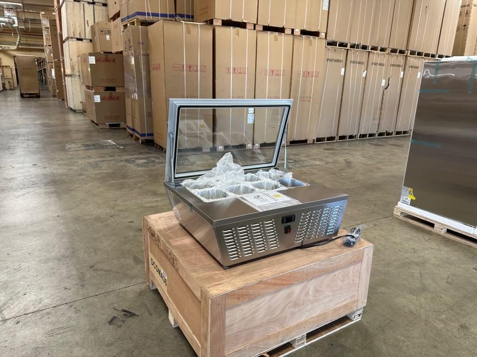 Side view of the cooler depot CW-67 unit on a wooden pallet, showing the ventilation grilles and power cord.