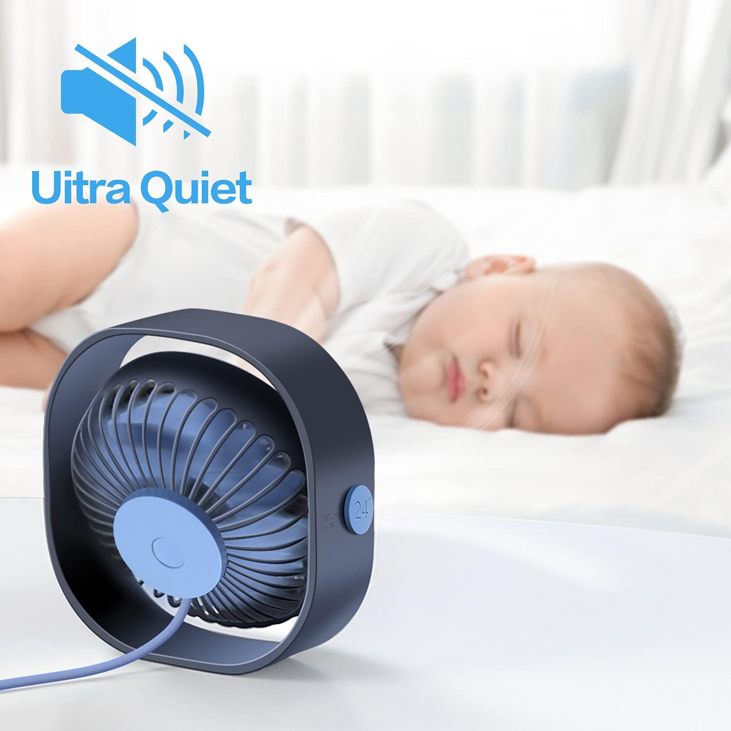 Baby sleeping peacefully next to the fan, indicating quiet operation