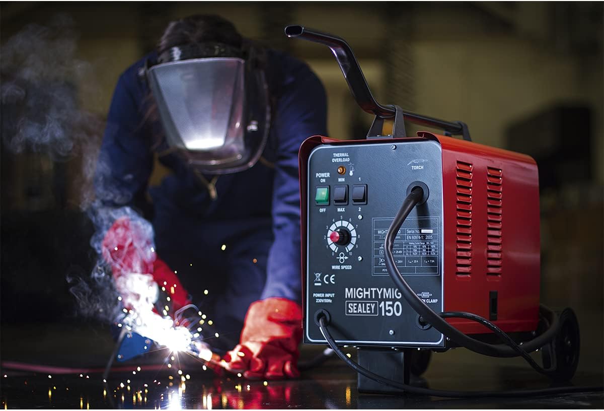 Welder in use, showing sparks and a person wearing a welding helmet