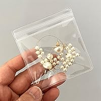 Vista 1 de Paquete de 100 bolsas de plástico transparentes de cloruro de polivinilo antioxidación para embalaje joyas anillos aretes bolsa de polietileno