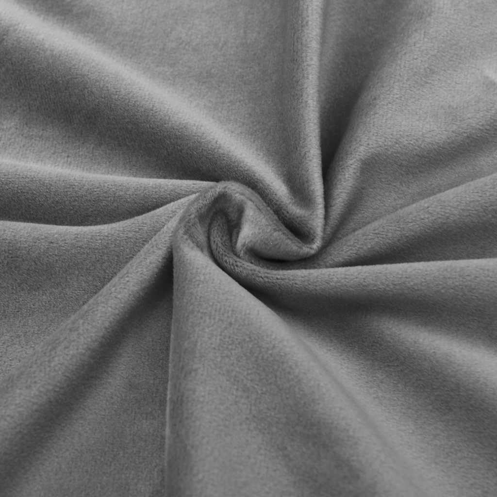 Close-up texture of the soft grey velvet fabric of the curtain.