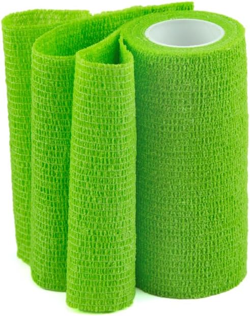 Multiple folds of bright green self-adhesive bandage standing upright next to a full roll.