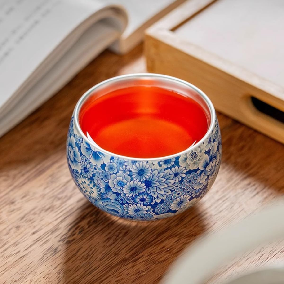 Handcrafted sterling silver teacup with intertwined lotus pattern, a high-end Chinese-style personal teacup/tea bowl, presented in a gift box packaging.
